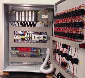 The inside of the control cabinet with the Siemens S7 PLC.